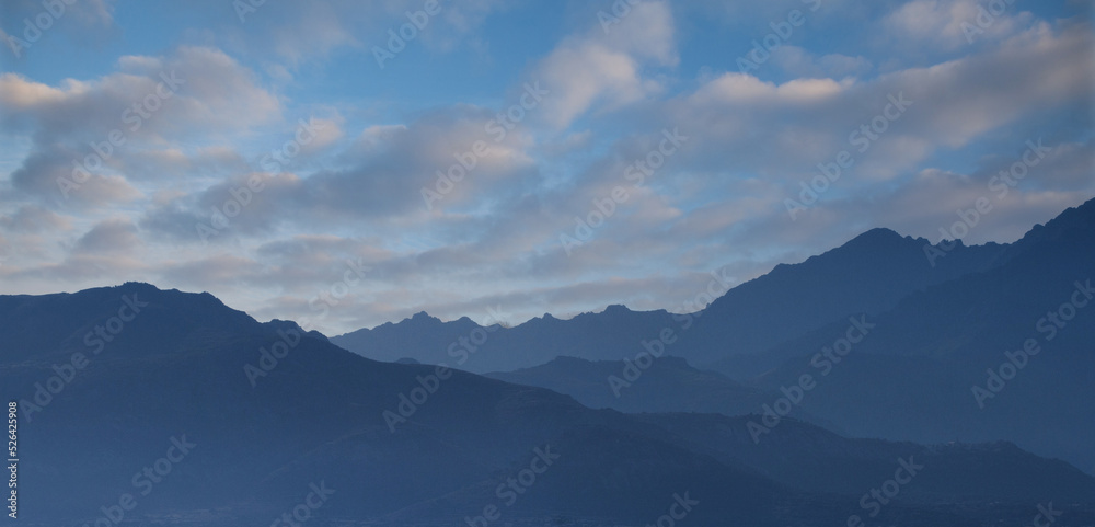 Fototapeta premium Mountains behind the village of Lumio Corsica on the mediterranean sea