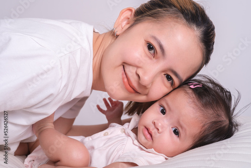 Portrait of happy mother and baby. Happy mom smile with family and love newborn.