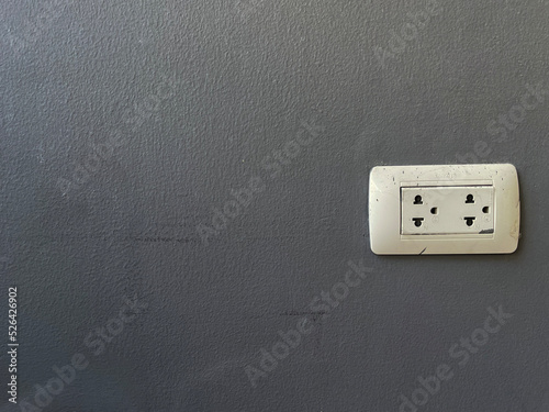electrical outlet on a grey wall.
