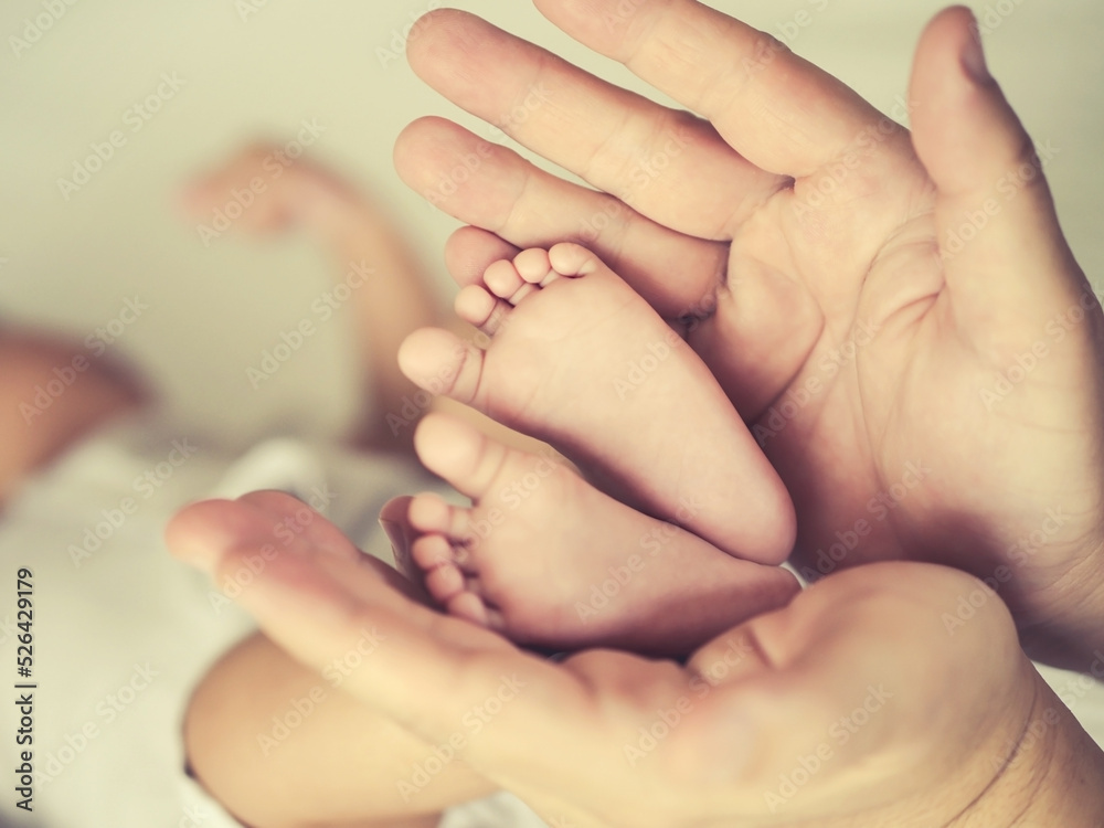 Selective focus close up feet of a newborn baby in parent 's hand , Parental care and happy family concept Selective focus close up feet of a newborn baby in parent 's hand , Parental care and happy family concept