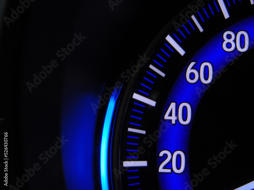close up of a speedometer on black
