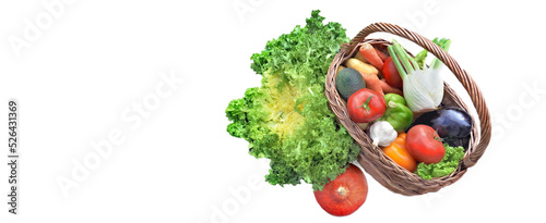 view above a basket full of fresh and varied vegetables isolated on white pan...