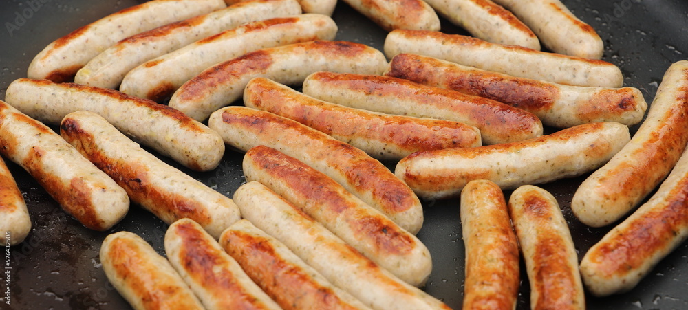 lots of delicious fried sausages in the pan lots of delicious fried sausages in the pan