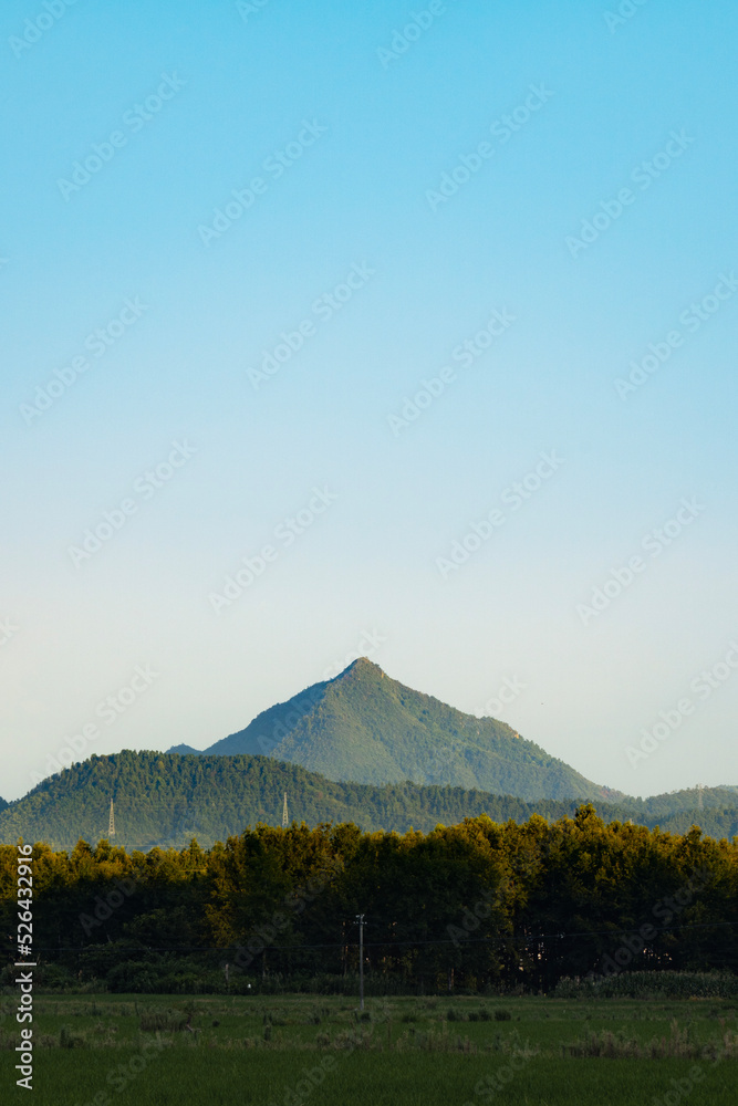 Fototapeta premium mountain in summer evening with sun light shed on the peak of the mountain