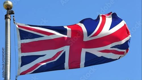 A slow-motion of a waving United Kingdom flag during a sunny day.
