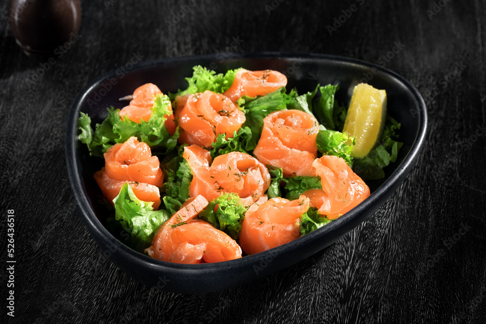 close up view of nice yummy salmon salad in grey back close up view of nice yummy salmon salad in grey back