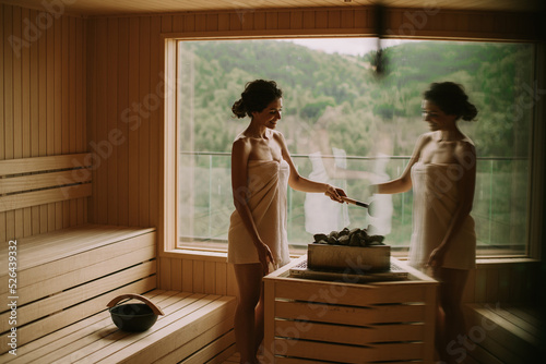 Young woman pouring water o...