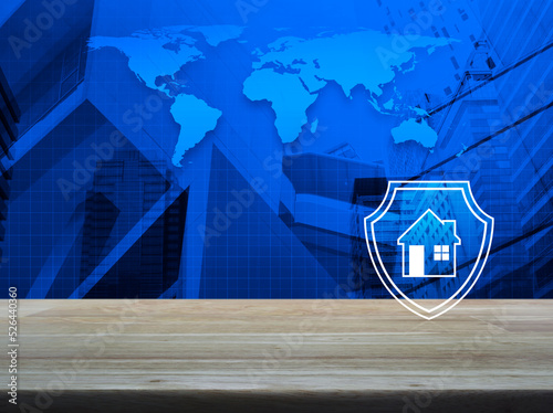 House with shield flat icon on wooden table over world map  modern city tower and skyscraper  Business home insurance and security concept  Elements of this image furnished by NASA