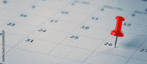 Embroidered red pins on a calendar event Planner calendar,clock to set timetable organize schedule,planning for business meeting or travel planning concept.