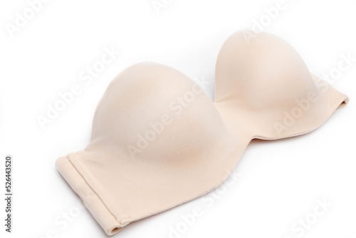Bra woman isolated. Close-up of a luxurious elegant nude strapless bra isolated on a white background. Underwear fashion. Front view. photo