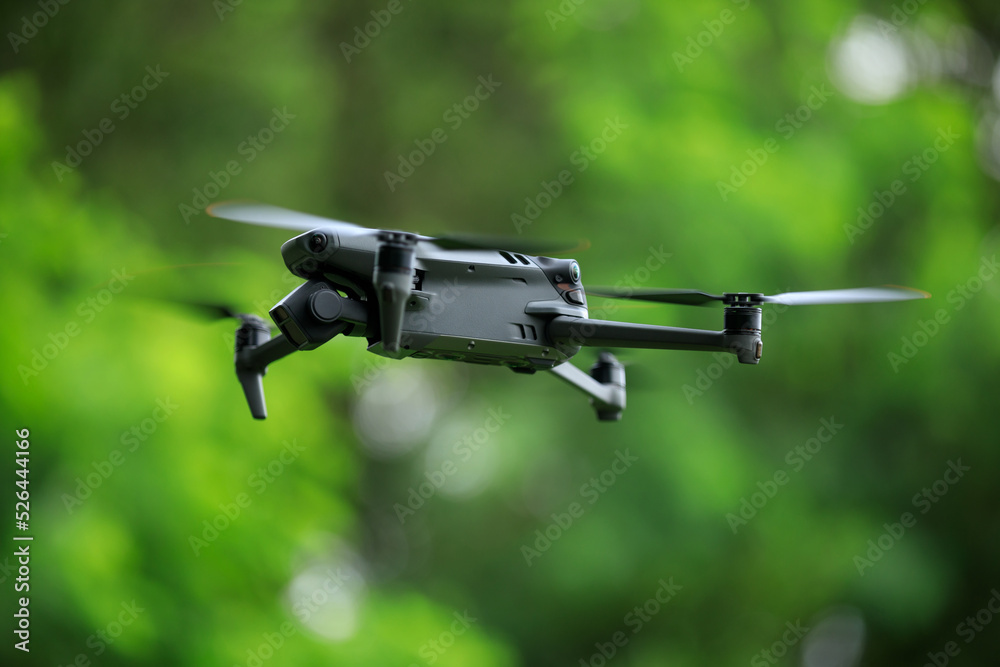 Flying drone in summer forest