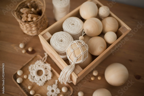 Macrame decor in a wooden box, Christmas ball and stars, handmade, hobby materials.