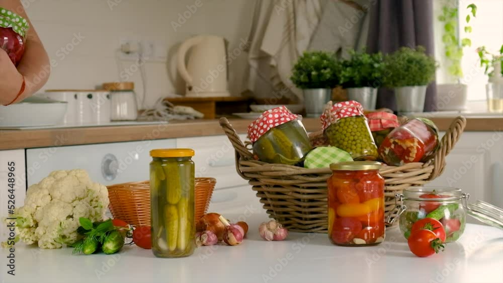 Woman jar preserve vegetables in the kitchen. Selective focus. Woman jar preserve vegetables in the kitchen. Selective focus.