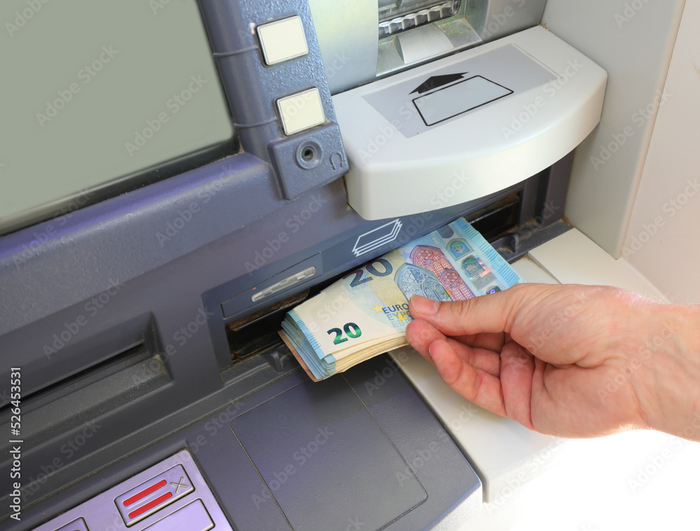 hand picking up Euros 20 banknotes on the ATM of the bank hand picking up Euros 20 banknotes on the ATM of the bank