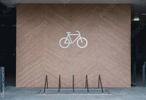 Front view of a large sign for bicycle parking on the wall. Bicycle parking in city.