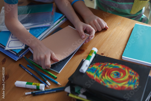 Children preparing for the new school year; new notebooks and school supplies