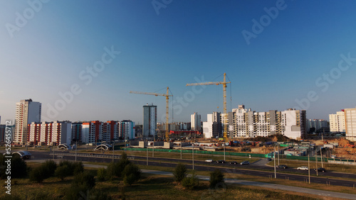 Construction site of a new city block. Construction of multi-storey buildings. Construction site at dawn. Aerial photography.