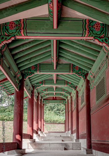Colorful traditional wood Korean architecture temple red and green pattern walkway Gyeonghuigung Palace in Seoul South Korea