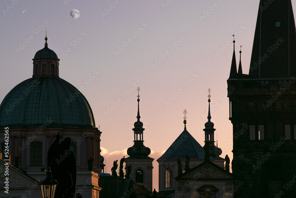 Prague silhouettes at dawn with the moon in the sky