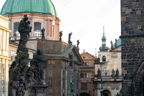 glimpse of prague with palaces decorated with ancient statues photo