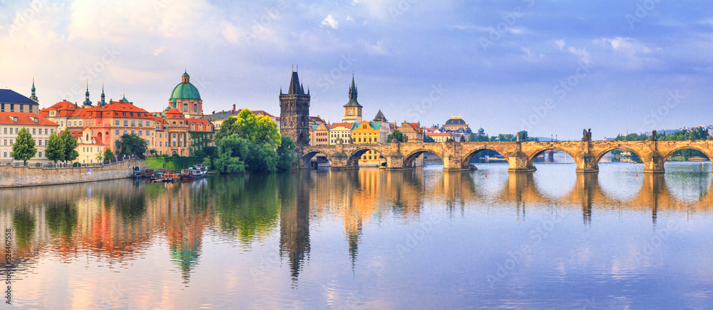City summer landscape at sunrise, banner - view of the Charles Bridge and the Vltava river in the historical center of Prague, Czech Republic