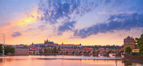 City summer landscape at sunset, panorama, banner - view of the Charles Bridge and castle complex Prague Castle in the historical center of Prague, Czech Republic