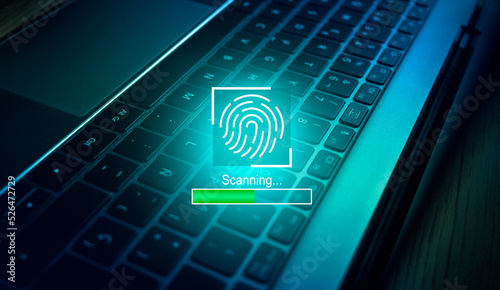 Biometric authentication concept. fingerprint scanning with laptop keyboard as background. Access password thru fingerprints. Technology security system. © Elena Uve