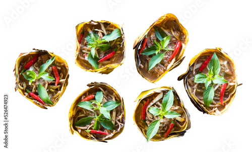 Isolate top view of curried fish wrapped in banana leaves and steamed banana.