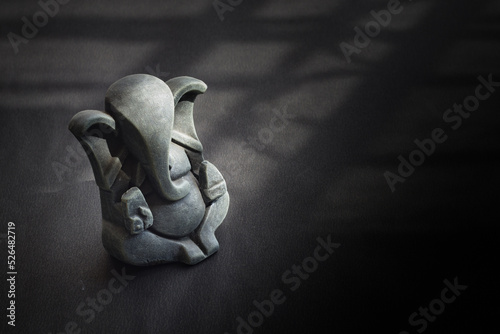 idol of lord ganesha for worshipping during ganesh chaturthi festival in maharashtra india. shot against black background.