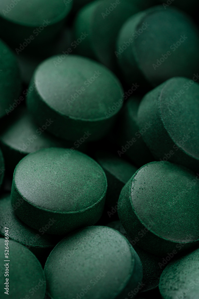 green pills spirulina. macro photo of green pills StockFoto Adobe Stock