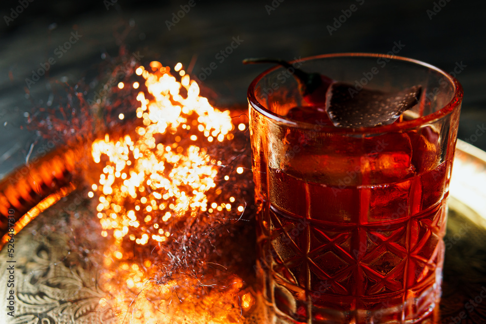Alcoholic drink. A cocktail with whiskey or cognac on the table, close-up, dark background. Concept of elite alcohol and nightlife. Alcoholic drink. A cocktail with whiskey or cognac on the table, close-up, dark background. Concept of elite alcohol and nightlife.