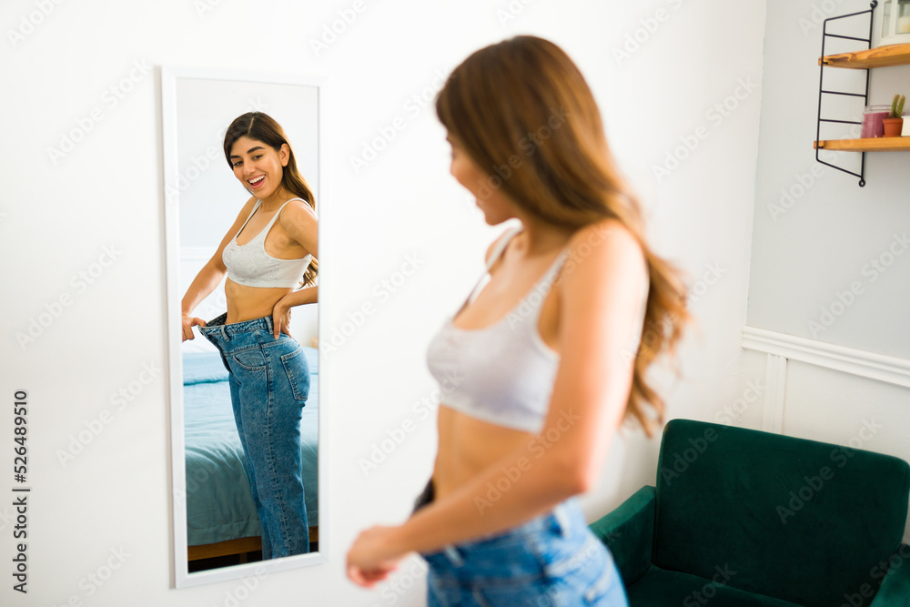 Fototapeta premium Cheerful woman can wear smaller sizes of her clothes