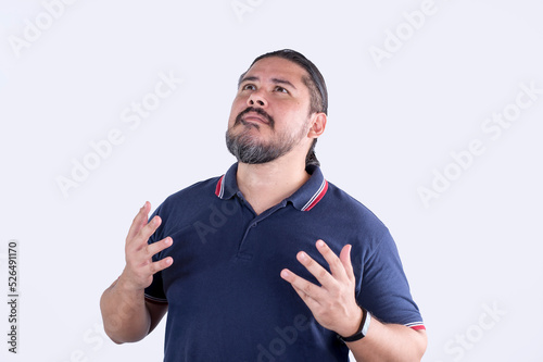 A man procrastinating and complaining to a higher power. An agnostic person feeling forsaken. A guy in his 30s in a white background. photo