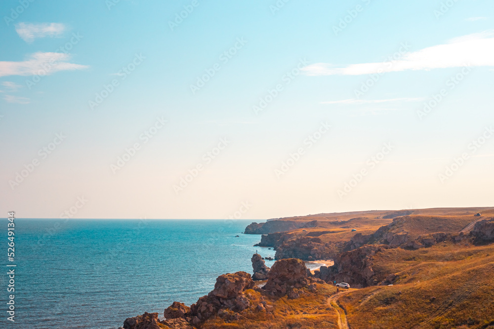Seascape. Blue sea and rocky mountains with blue skies on the horizon. Travel and tourism