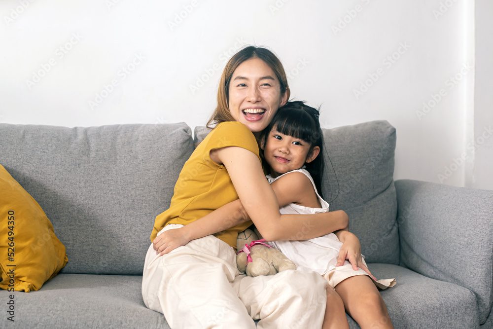The daughter expresses joy, hugs her mother and smiles. The daughter expresses joy, hugs her mother and smiles.
