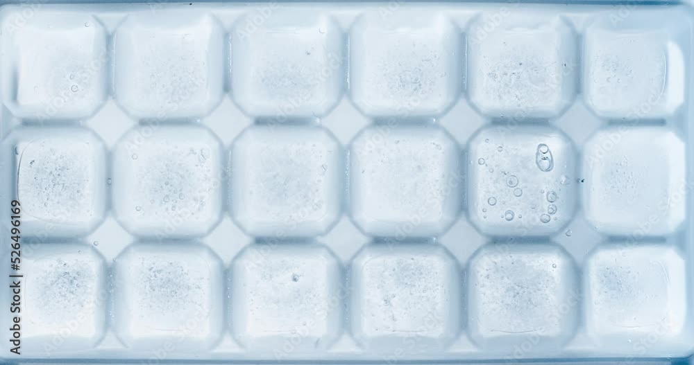 Timelapse of water freezing ice cubes in an ice tray.