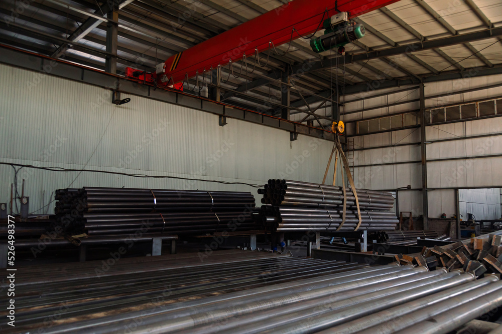Stainless steel pipes of metal stacked up in a warehouse