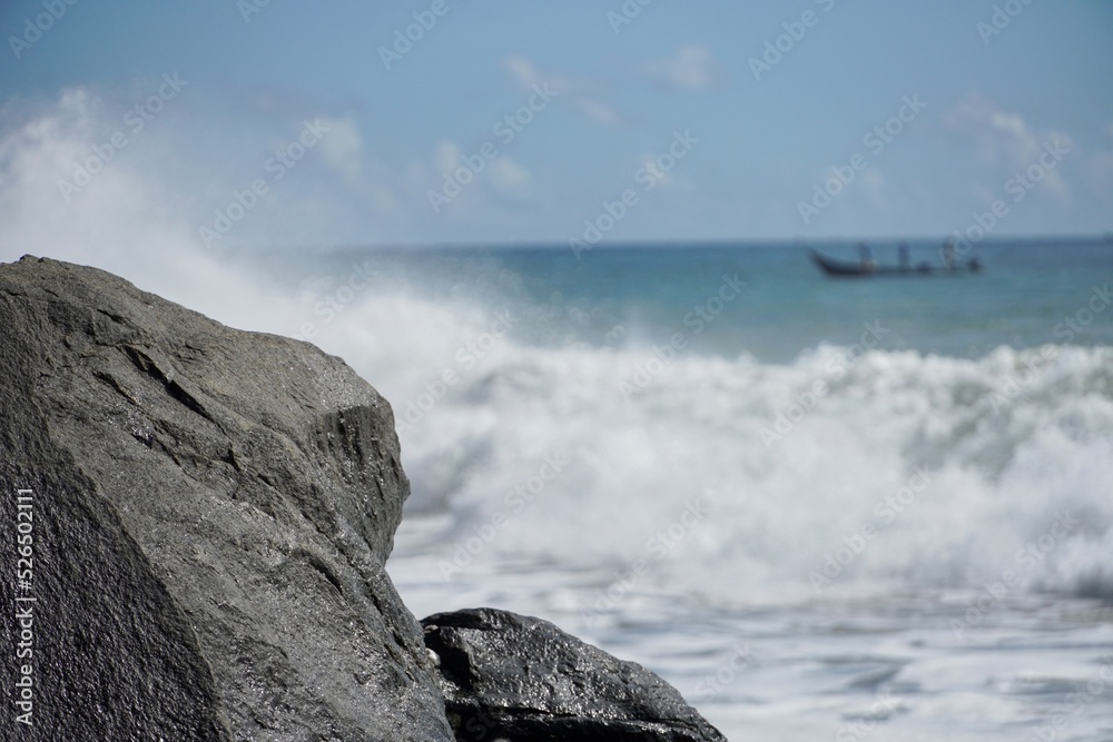Power of sea waves in the coastal seashore of Mahabalipuram beach, Tamilnadu, India. Sailing Boat in the sea