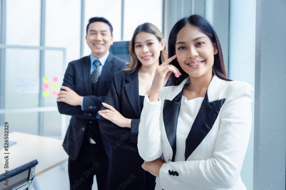 Portrait of Asian business group people in suit standing smiling  in modern office