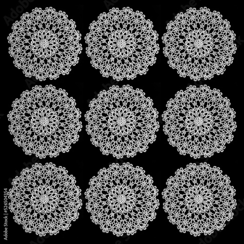 Decorative set of nine handmade lace doilies on a black background