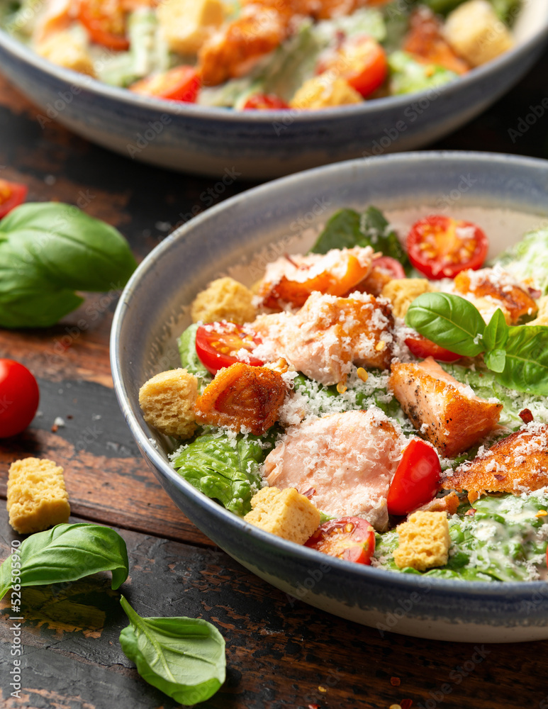 Salmon Caesar salad with grilled fish, croutons and cherry tomatoes Salmon Caesar salad with grilled fish, croutons and cherry tomatoes