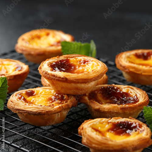 Traditional Portuguese custard tarts or Pastel de Nata freshly baked and cooling on rack