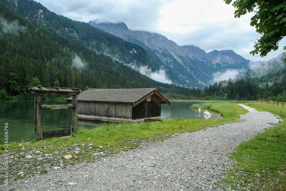 The glacier lake Jägersee in Austria in the Alps during the rainy and cloudy day. Travel destination for the tourists. The glacier lake Jägersee in Austria in the Alps during the rainy and cloudy day. Travel destination for the tourists.