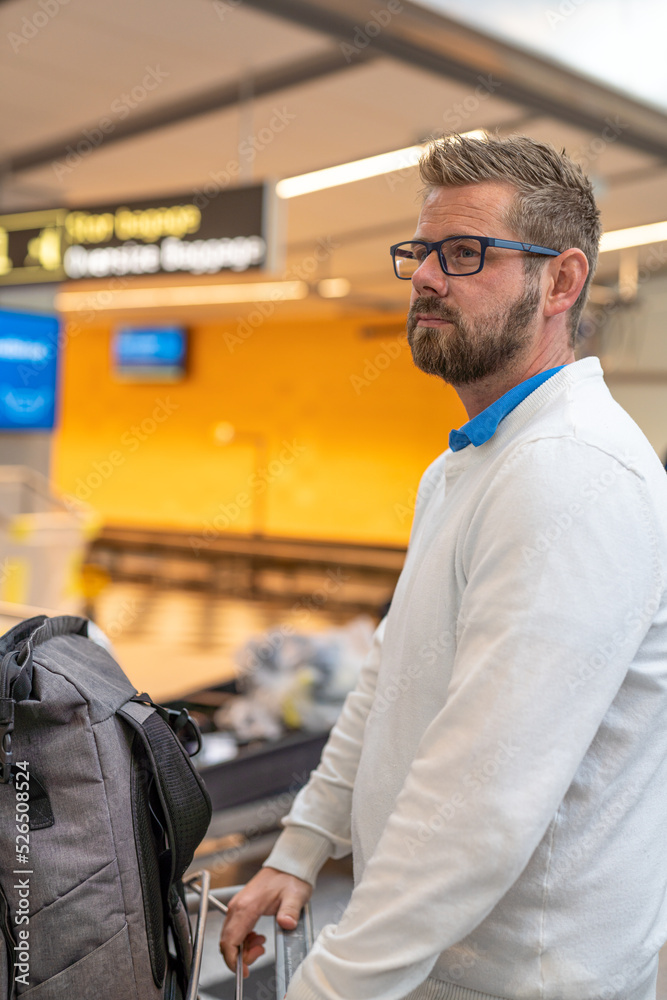 Portrait of the young traveler with suitcase at the airport. Portrait of the young traveler with suitcase at the airport.