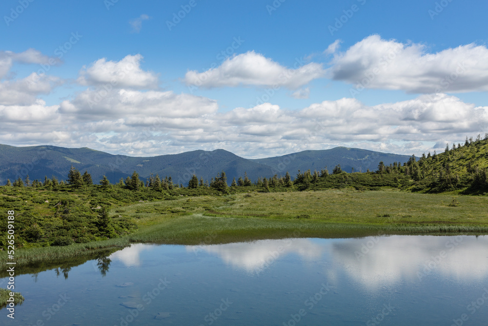 The water surface of a blue lake against the background of the Gorgan mountain range, Carpathians