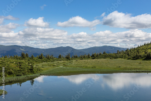 The water surface of a blue lake against the background of the Gorgan mountain range, Carpathians