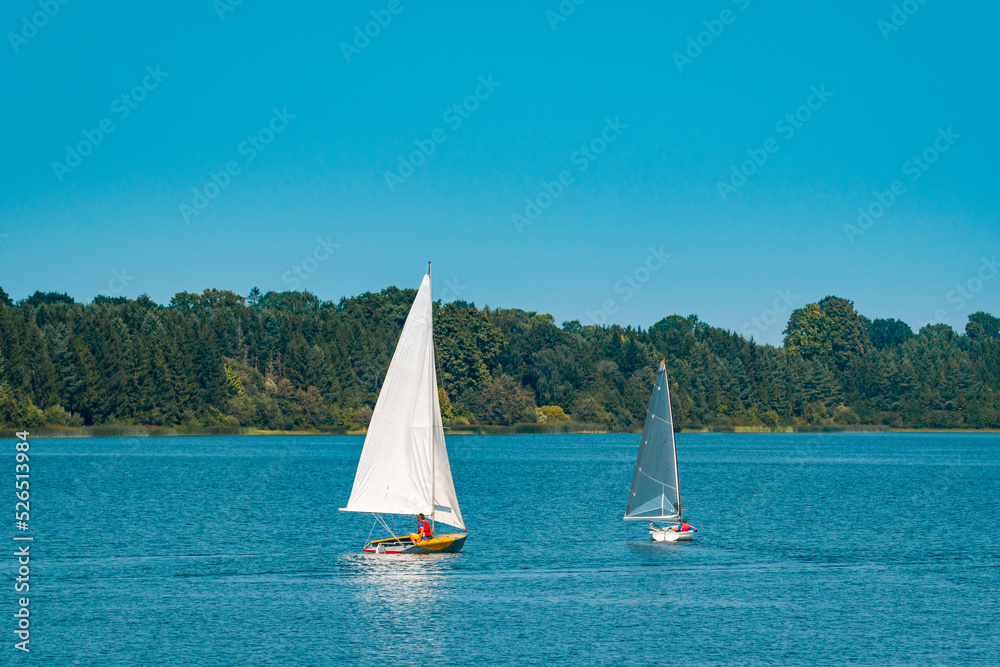 Two small yachts sailing on the lake