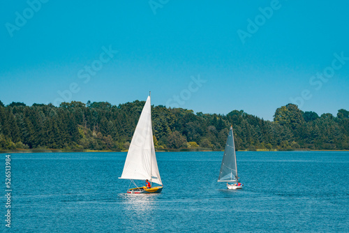 Two small yachts sailing on the lake