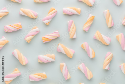 Colorful marshmallows on pastel background.