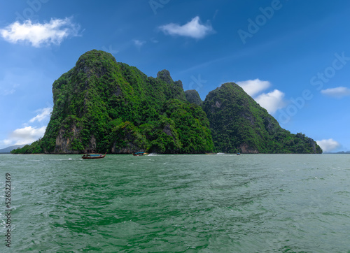 Phangna Bay near the Island of Phuket Thailand. Lovely rock in the middle of the ocean surrounded by mountains